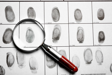 Criminal fingerprint card and magnifier, top view