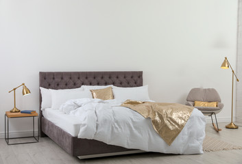 Fototapeta na wymiar Large comfortable bed in stylish room. Modern interior design