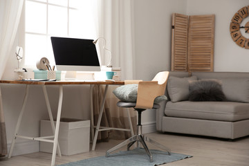 Light work place with computer near window at home. Interior design