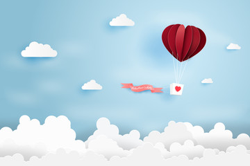Heart air balloon made origami float over blue sky,Paper art style.