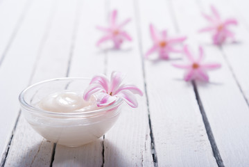 moisturizer with hyacinth on white wood table