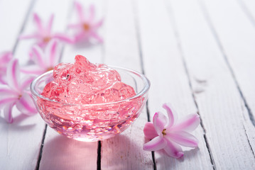 anti aging gel and hyacinth flowers on white wood