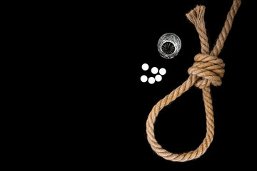 Rope, pills and glass of alcohol (vodka) on black background. Suicide. Running knot. 