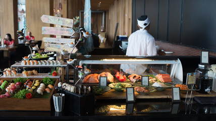 chef in the kitchen Japanese sushi bar buffet in hotel