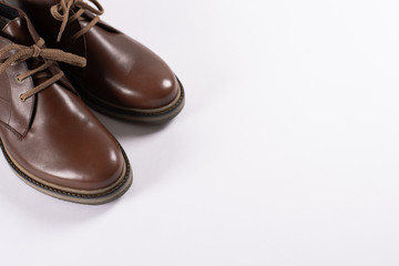 Brown male shoes on white background. Space for text. Male fashion.