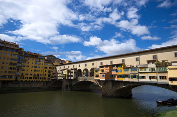 Fototapeta na wymiar Florence / Italy - September 24 / 2015 : View of Ponte Vecchio, the closed stone bridge over Arno river of Florence
