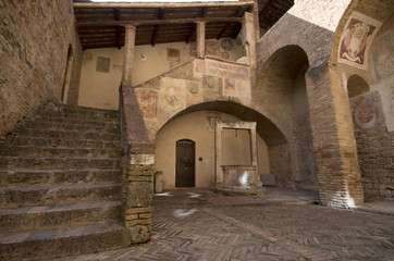 Siena / Italy - September 25 / 2015 : Entrance of Torre Grossa at City Hall, aka. Palazzo Comunale and Palazzo del Popolo  of San Gimignano
