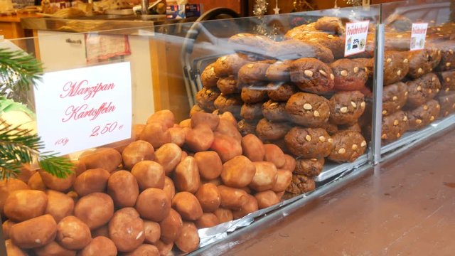 Traditional Christmas Nuremberg chocolate and ginger gingerbread and marzipan potatoes on the windows of Christmas market. Christmas spirit. Traditional German lebkuchen