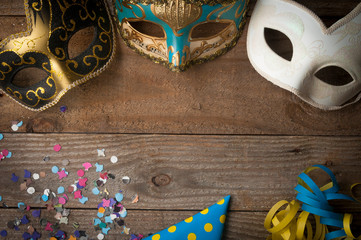 Mardi gras masks on wooden table © cristianstorto