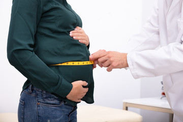 Doctor Checking Growth Of Baby With Measuring Tape