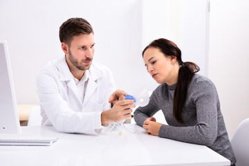 Doctor Giving Information On Using Oxygen Mask To Woman