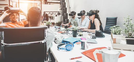Young teamwork using virtual reality glasses in coworking creative office