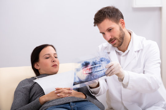 Male Doctor Explaining X-ray To Patient