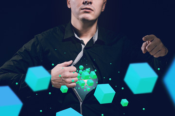 A man in a black shirt plays with his hands with futuristic cubes. Unreal business and IT...