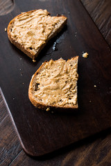 Creamy Peanut Butter with Bread on Wooden Board.
