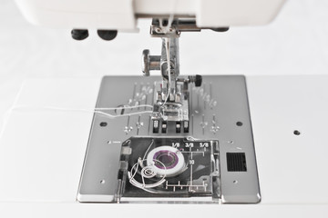 Sewing machine working parts, presser foot needle and spool