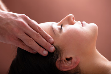 Fototapeta na wymiar Therapist Massaging Woman's Head