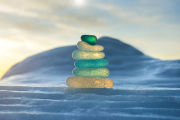 Stack of glass pebble on sunset
