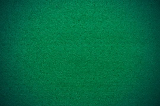 Green felt background with vignette, closeup
