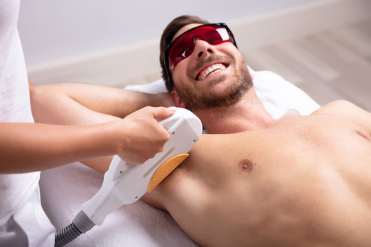 Young Man Having Underarm Laser Hair Removal Treatment