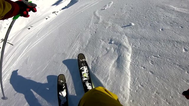 winter freeride skiing in powder fresh snow in alps on sunny day gopro chest mount