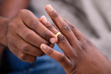 Man Putting An Engagement Ring On Woman's Finger