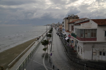 view of the city, Larnaca main street, promenade along sea, swirling rainy clouds