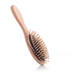 Wooden comb with black hair loss problem studio shot and isolated on white