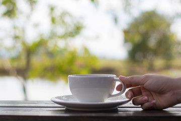 Coffee espresso on wood table nature background in garden,warm tone
