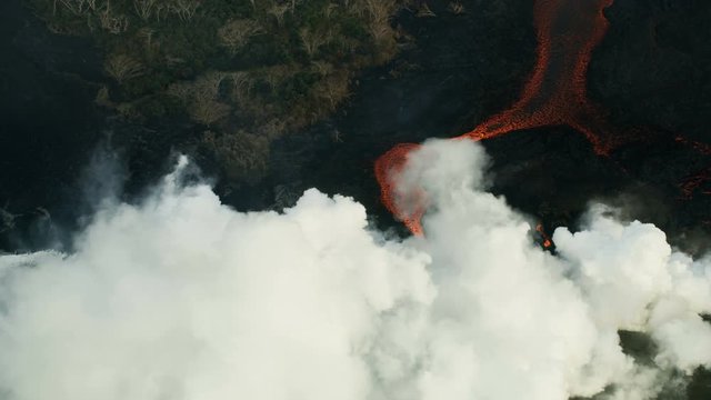 Aerial view red hot lava pouring into Pacific