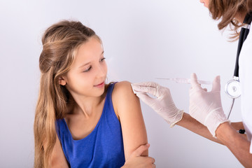 Doctor Injecting Syringe To Patient