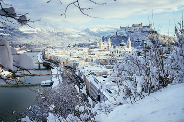 Obraz na płótnie Canvas Panorama of Salzburg in winter: Snowy historical center, sunshine