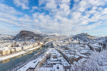 Fototapeta premium Panorama of Salzburg in winter: Snowy historical center, sunshine