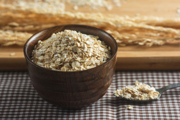 Dry oats in a wooden cup.