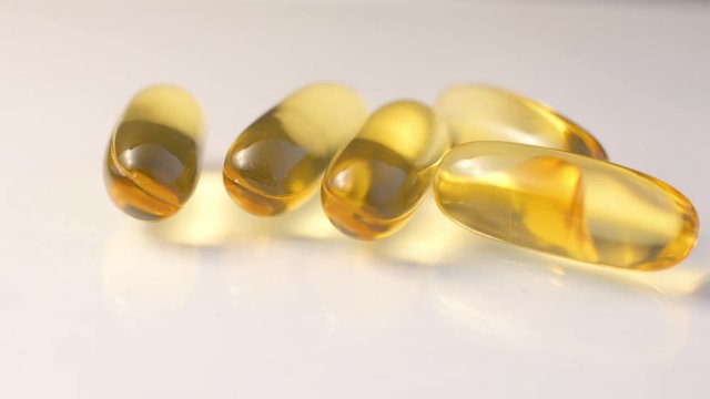 Image of few vitamin E capsules isolated over white background.