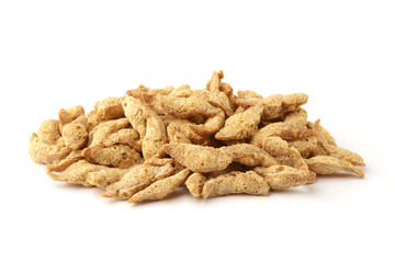 Raw soy chunks pile isolated on white background. Dry soya pieces meat used in vegetarian and vegan food.