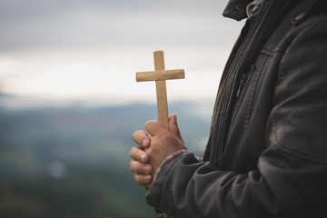Human hands holding a cross holy and prayed for blessings from God,  Amour Worship God concept. - Image