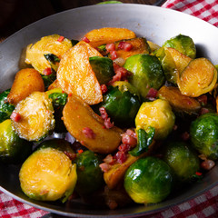 Brussels sprouts potato pan with bacon in rustic style