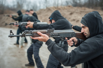Large team action training with rifle machine gun. Shooting range