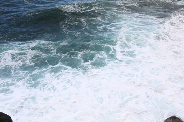 Fototapeta na wymiar Waves of the sea are beating on the stones
