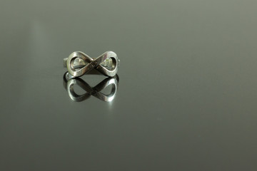 infinity ring with reflection isolated on black 