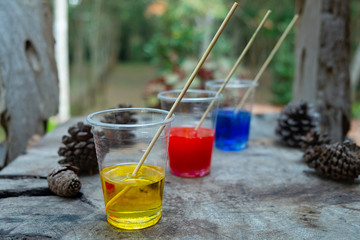 Epoxy resin Red yellow blue color in cup for casting Stabilizing wood and pine cone hybrid, abstract art background