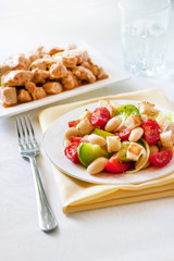Fototapeta na wymiar Salad with three kinds of tomatoes, boiled white kidney beans and croutons from white bread
