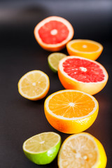 Fototapeta na wymiar Different fruits in a cut on a black background