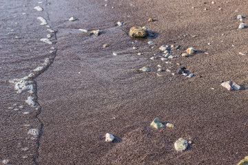 wet sand and stone sea waterfront shoreline perspective photography foreshortening background wallpaper idyllic post card concept, empty copy space for your text or inscription