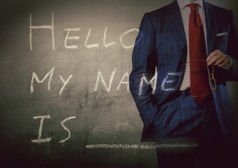 Self Introduction - Hello, My name is ... written on a blackboard with businessman