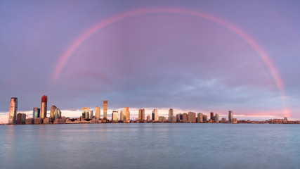 Rainbow over Jersey City view from Hudson river