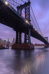Manhattan Bridge view at night from East river with long exposure