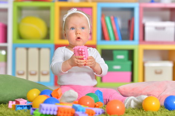 Portrait of little child playing with colorful toys