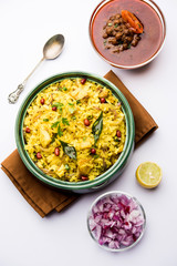 Aloo/Kanda Poha or Tarri Pohe with spicy chana masala/curry. selective focus